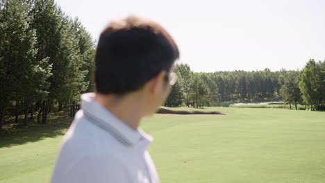 Asian-gentleman-moving-his-head-on-golf-field