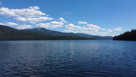 Drone-taking-off-towards-an-alpine-lake-in-northern-idaho