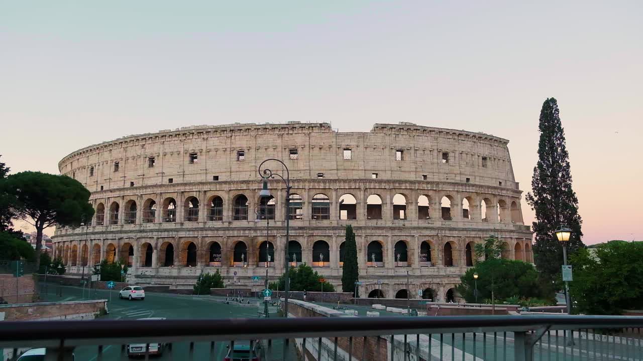 Static wide shot of the colosseum during sunrise.