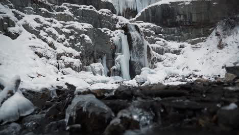 tilt up revealing the stunning frozen stewart falls waterfall near sundance ski resort in provo that requires a small hike to arrive to