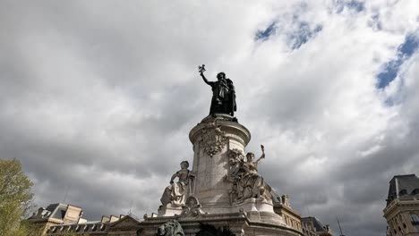 bronze statue of marianne with dynamic cloud backdrop