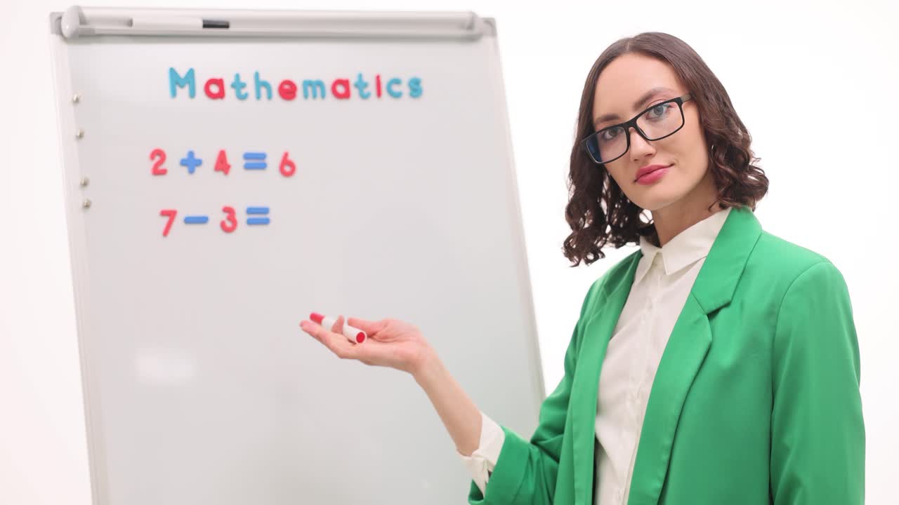 Mathematics Teacher Explaining Equations on Whiteboard