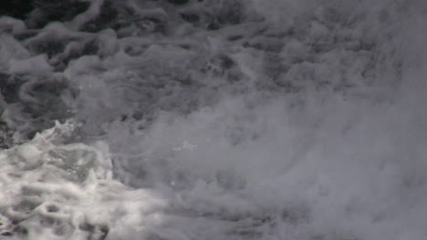 Side-mount-tech-scuba-diver-descends-under-turbulent-river-waterfall