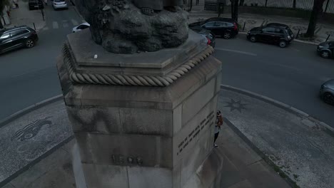 aerial bottom up view of central square which includes the statue of pedro álvares cabral and sign that welcomes people in lisbon