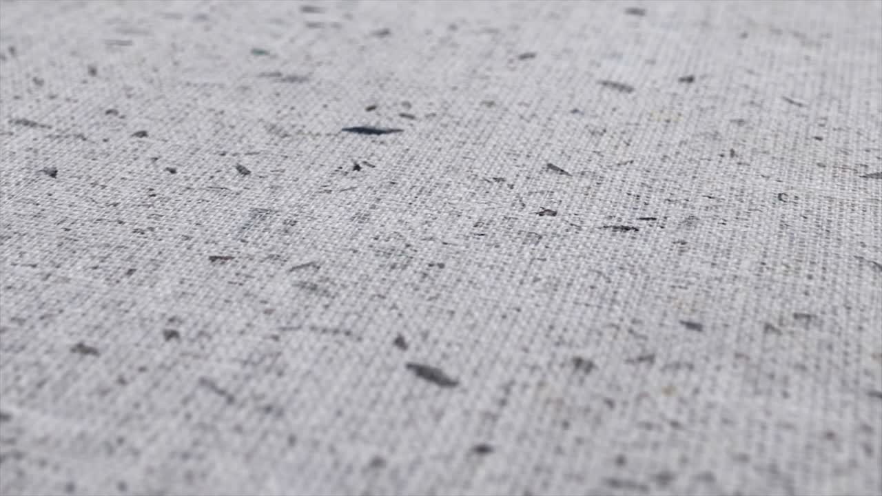 tela de tela manchada disparada de cerca. puntos negros sobre fondo blanco, patrón monocromático.