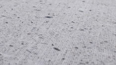 spotted fabric cloth close up shot. black dots on white background, monochrome pattern.