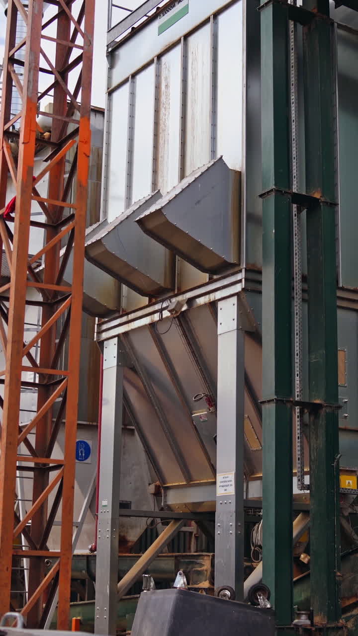 Big modernized factory outdoors. Woodworking plant. Modern metal construction of industrial plant outside. Vertical video