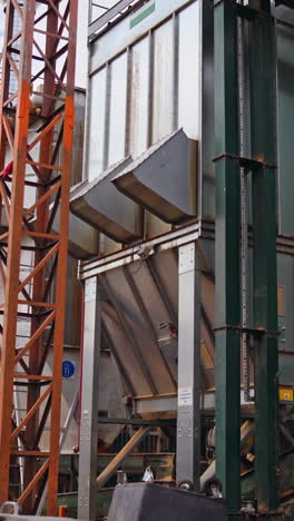 big modernized factory outdoors. woodworking plant. modern metal construction of industrial plant outside. vertical video