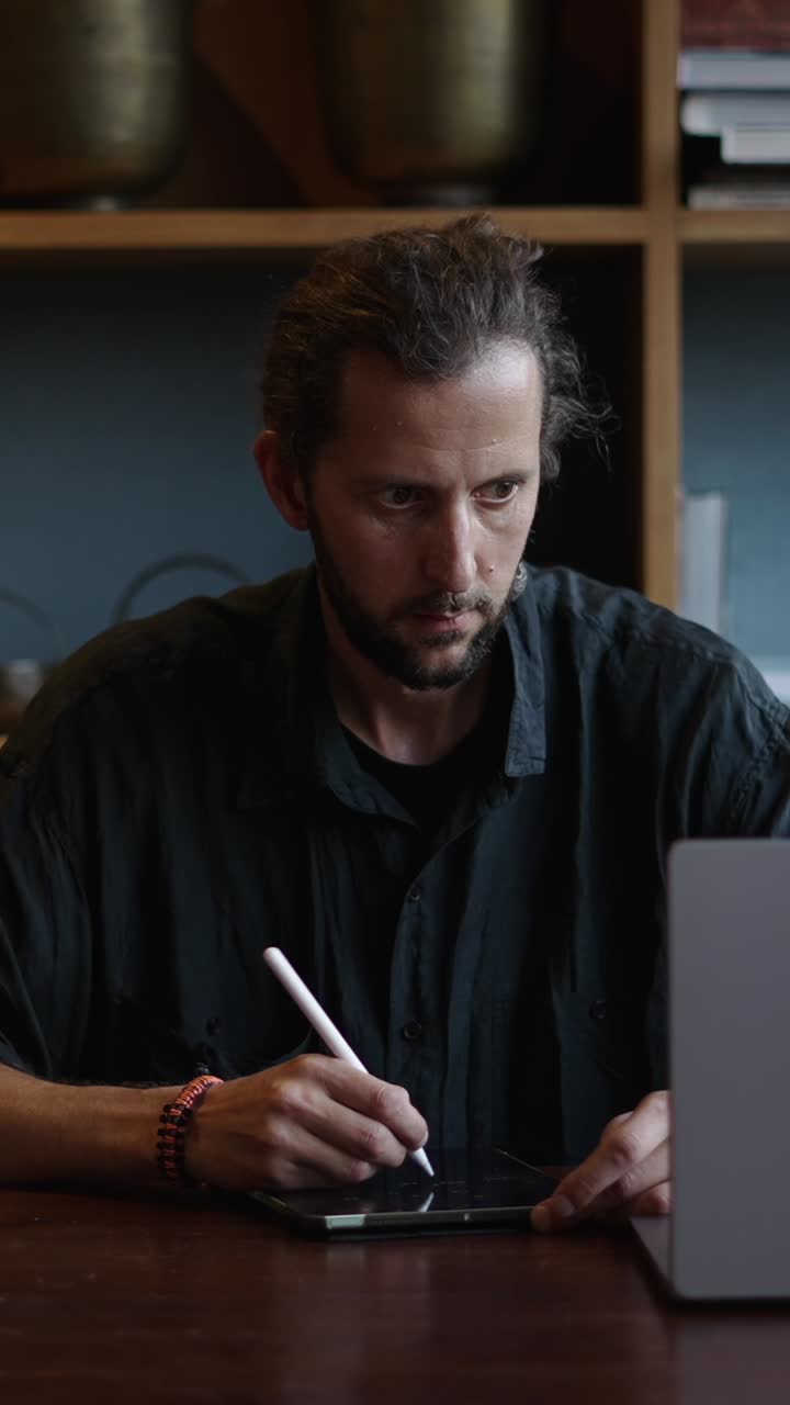 Man using a tablet with a stylus