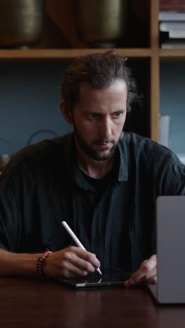 man using a tablet with a stylus