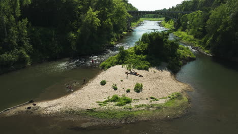 People-swimming-and-enjoying-public-water-Zumbro-river-in-Allis-Park,-aerial