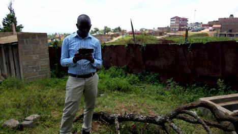 an african drone pilot flying drone in rural africa