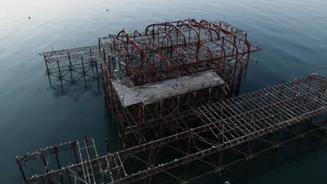 the skeletal remains of the west pier in brighton sussex, beyond repair after a series of arson attacks and storm damage