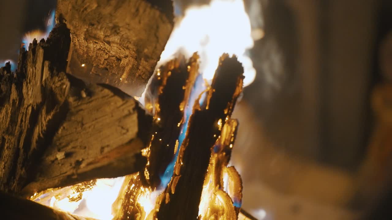 Slow-motion close-up of wood burning in a campfire during a camping trip in Guatemala