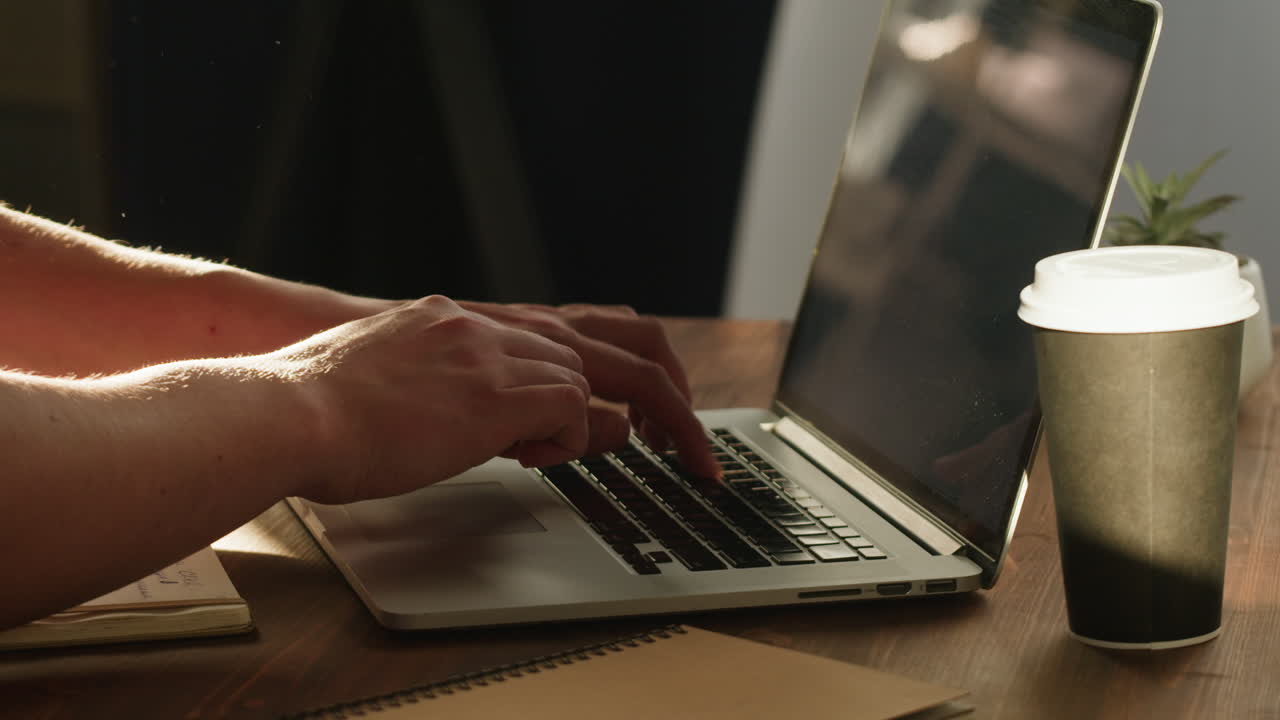 Close Up of Hands Typing on Laptop Keyboard at Desk