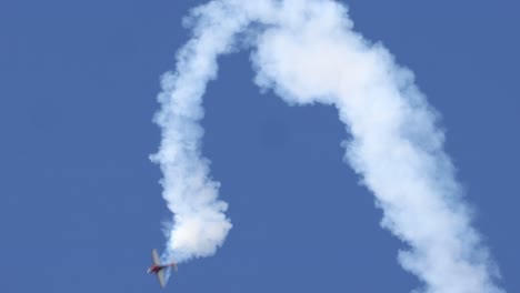 aircraft executes complex maneuvers in clear blue sky