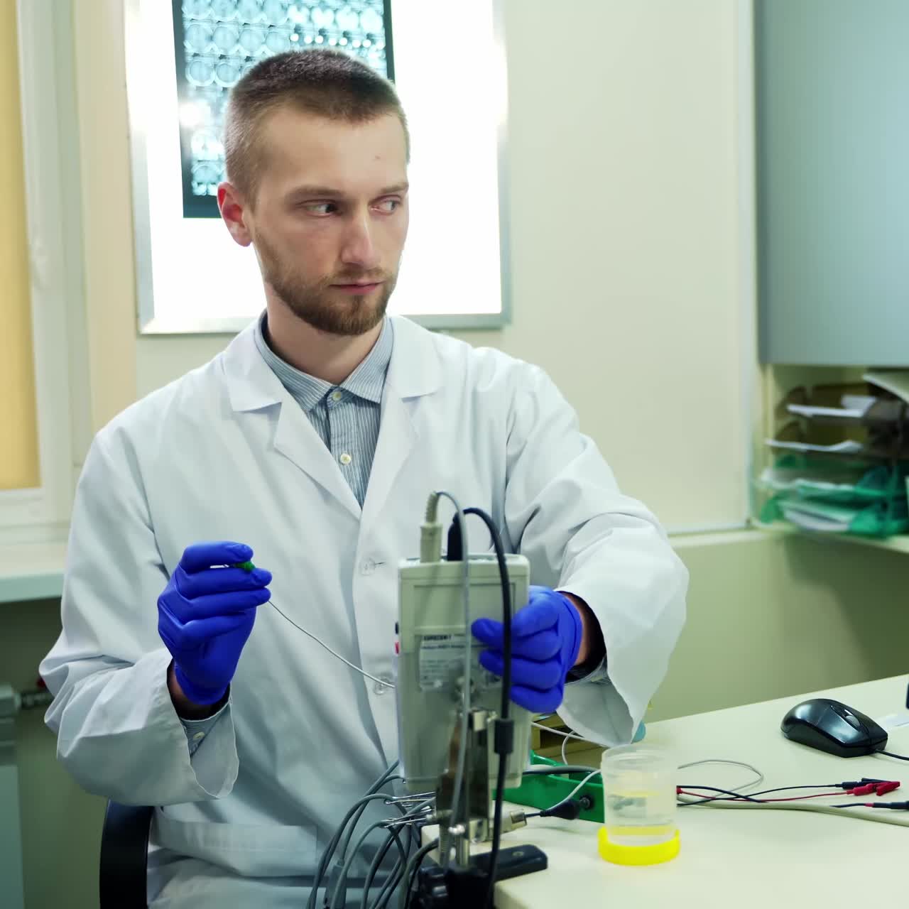 Doctor with medical equipment. Portrait of young doctor working with medical equipment