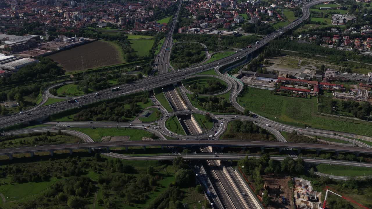 Highway complex traffic infrastructure, round about, intersection, multi lane transport. Milan, Italy, Aerial drone video
