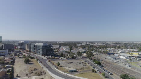 white birds flying through foreground of aerial perspective looking out over newly developed infrastructure in dandenong, victoria, australia