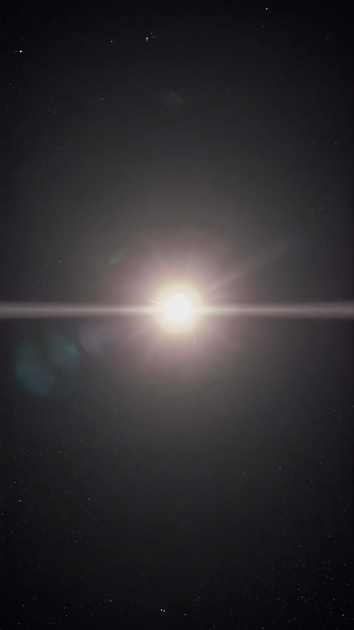 A cosmic video scene of a solar eclipse viewed from space. The wide-angle shot captures the sun's