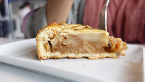 woman eating a slice of apple pie