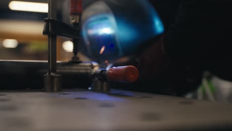 A-welder-in-a-helmet-is-working-at-the-plant