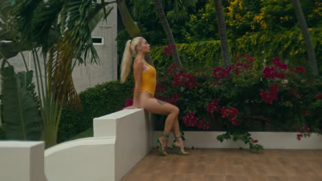 woman in yellow swimsuit by a pool