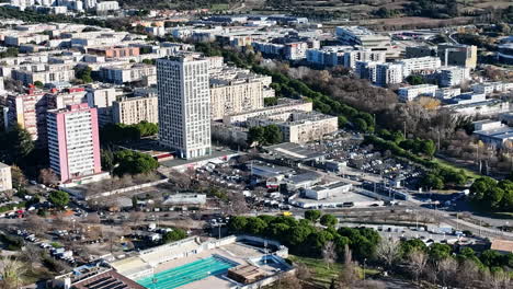 Aerial-view-of-la-Mosson,-Montpellier,-bathed-in-sunlight,-showcasing-its-vibran