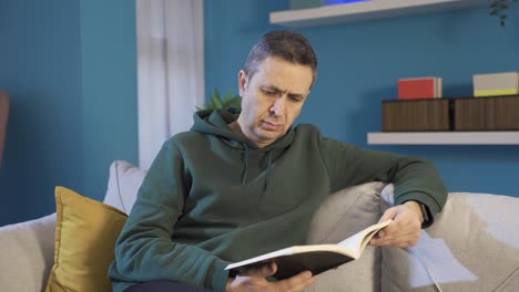 mature man reading a book alone at home.