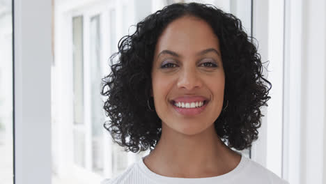 portrait of happy biracial woman at home, slow motion