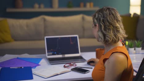 Investor-looking-at-the-stock-market-chart.-She-claps-when-she-wins.