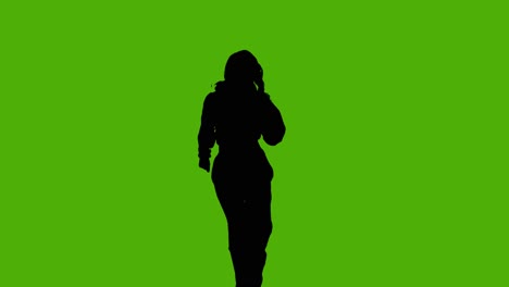 studio silhouette of woman dancing against green background 1