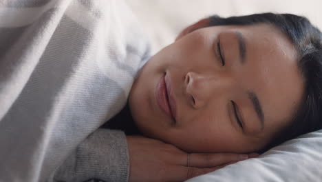 beautiful asian woman waking up in bed after restful sleep smiling happy ready for new day