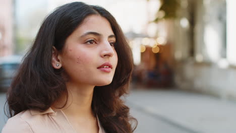 Close-up-portrait-happy-young-satisfied-Indian-woman-face-smiling-friendly-open-eyes-glad-expression