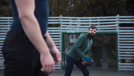 two men playing american football on an outdoor field