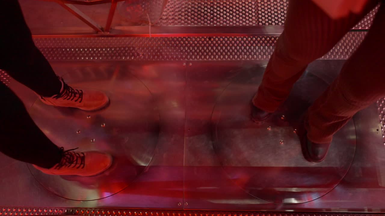 People's Feet on a Rotating Platform