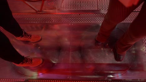 people's feet on a rotating platform