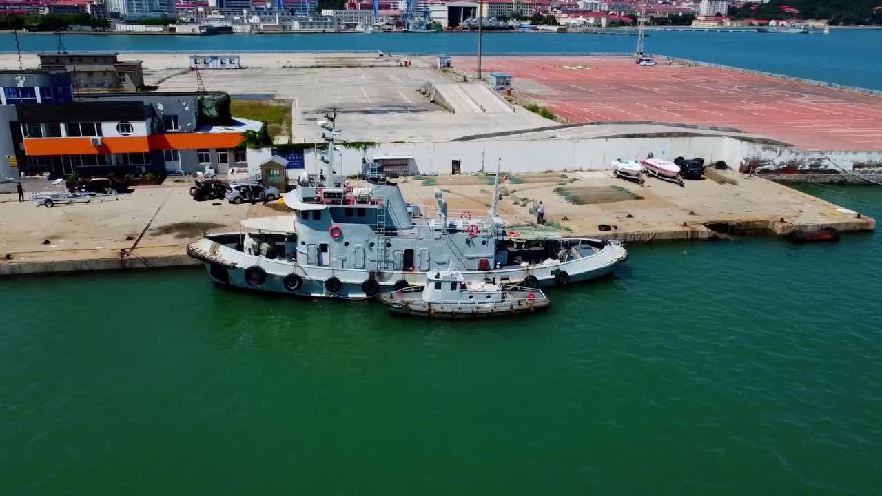 View of boats docked at Xingfu Park wharf pier Weihai aerial cinematic sliding shot