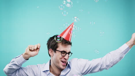 man celebrating with party hat and bubbles