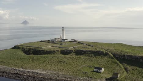 Aerial-view-of-Pladda-Lighthouse-on-the-Isle-of-Arran-on-a-sunny-day,-Scotland