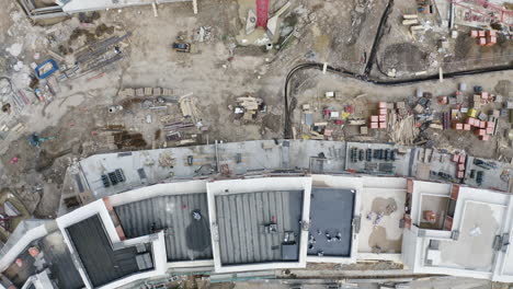 rooftops of newly built apartments at construction site,cranes,overhead