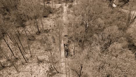 A-Black-and-White-Aerial-View-of-an-1860's-Steam-Passenger-Train-Traveling-Thru-a-Wooded-Area-on-a-Lonely-Single-Track