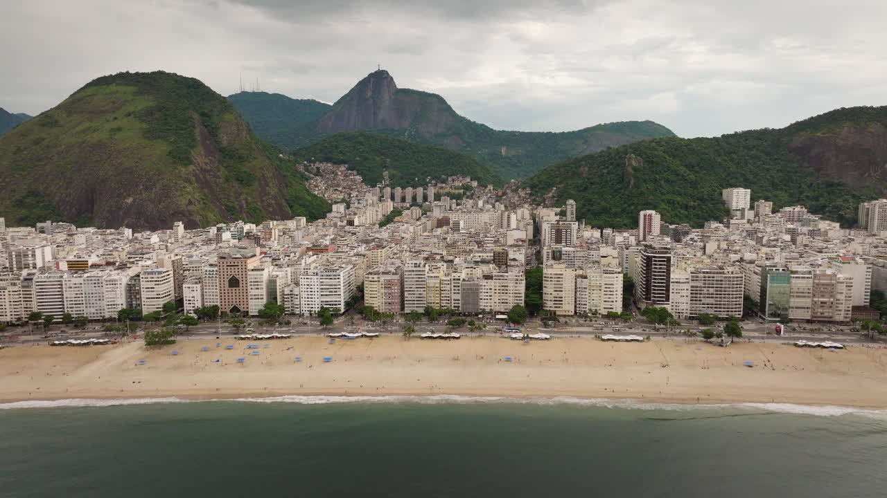 Aerial pullback view of Rio de Janeiro buildings and famous Copacabana beach