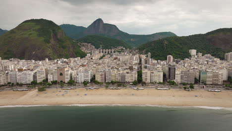 aerial pullback view of rio de janeiro buildings and famous copacabana beach