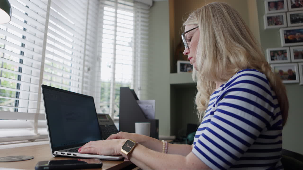 Woman working on laptop at home office