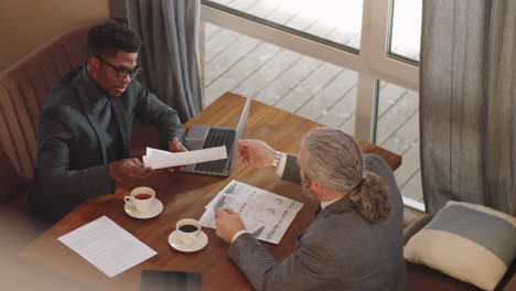 Multiethnic-Male-Business-Partners-Having-Meeting-in-Restaurant