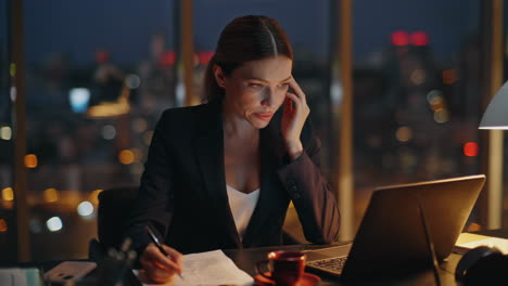 woman overwork late office typing laptop. busy manager analysing papers report