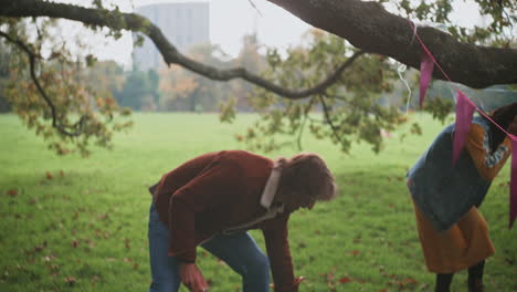 couple playing badminton in a park