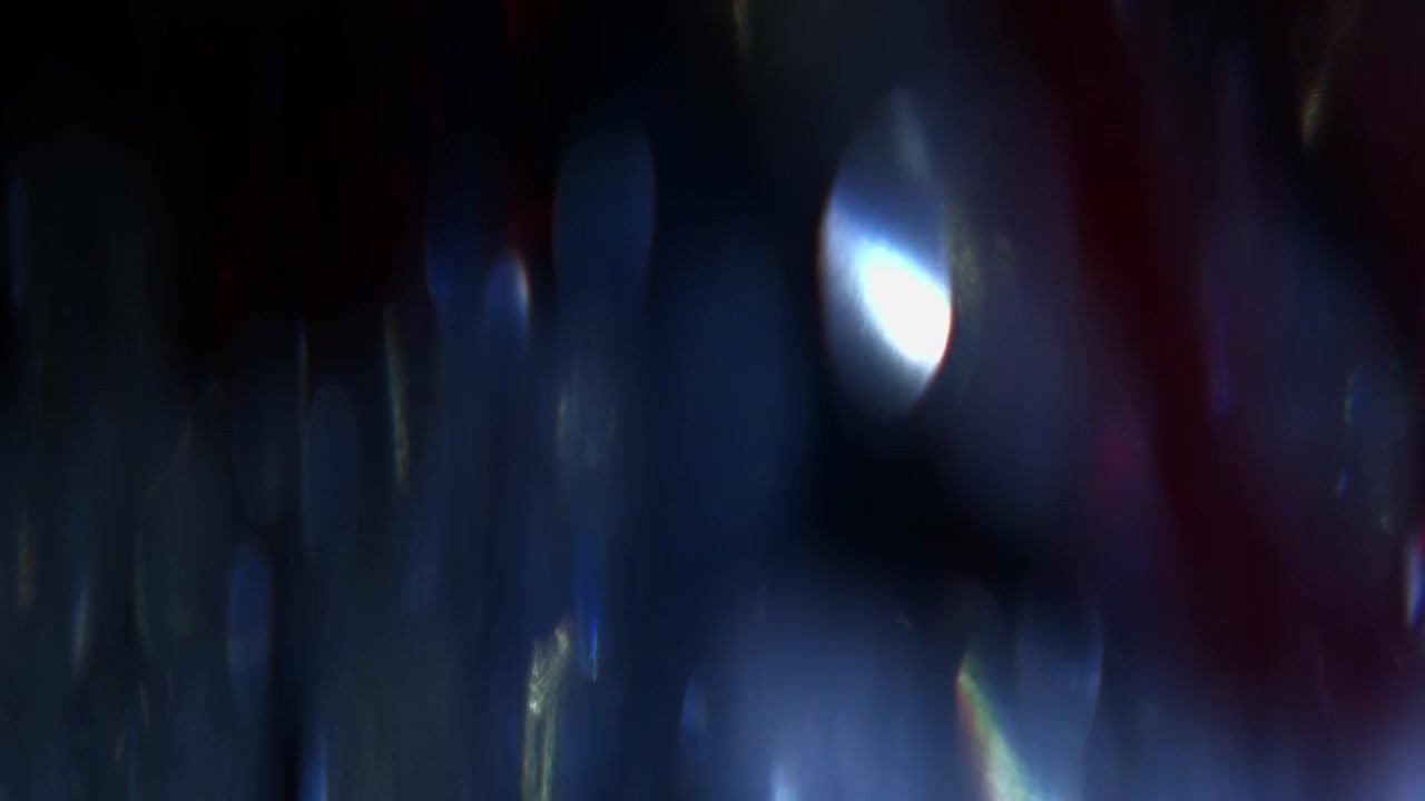 Abstract Light Leaks and Bokeh Reflections on Dark Background