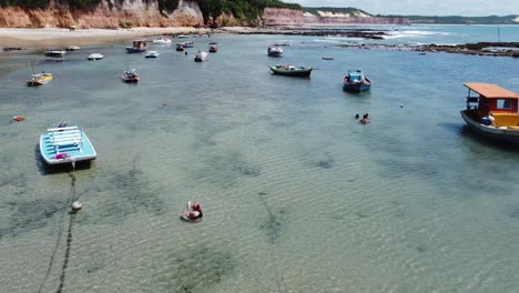 Panorámica-Sobre-Pequeños-Botes-En-Piscinas-De-Marea-Brasileñas-Cristalinas